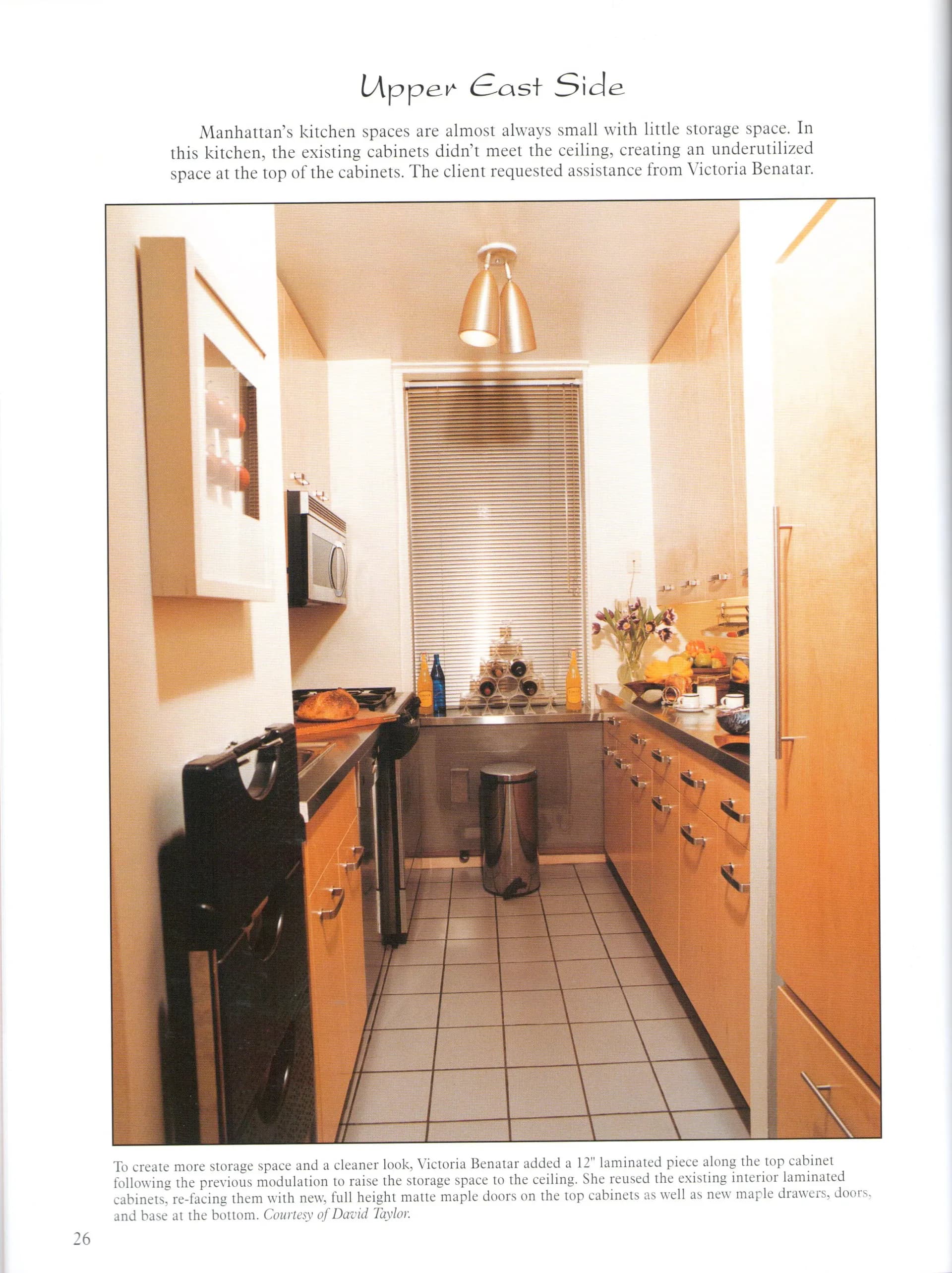 Narrow Manhattan kitchen with warm wood cabinetry, stainless steel appliances, and pendant lighting maximizing limited space by Victoria Benatar ARCHITECT PLLC.