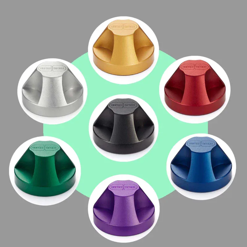 Seven colorful cone-shaped metallic objects arranged in a circular pattern on a mint green background with white circular frames, by WAXRAX.