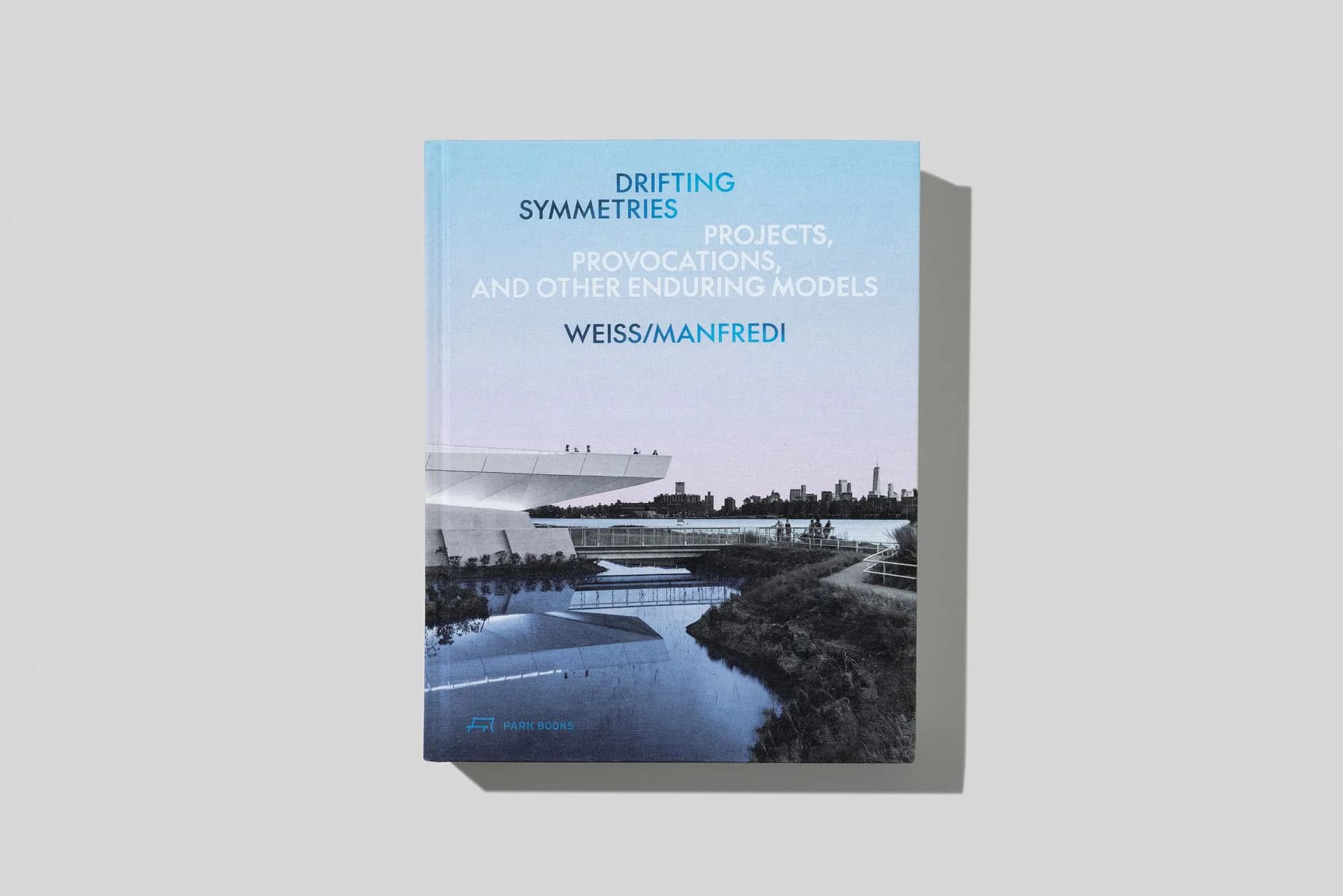 Book cover for 'Drifting Symmetries' featuring a landscape photograph of a winding river and forest by WEISS/MANFREDI.