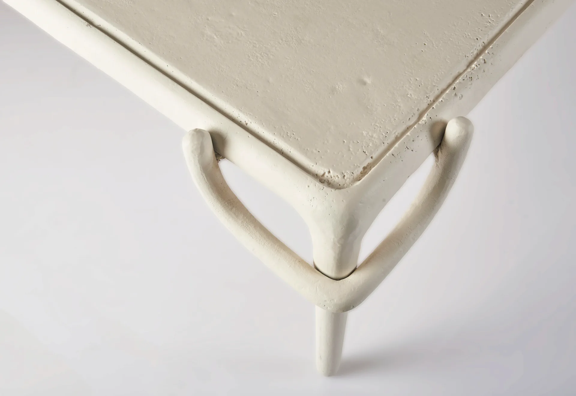 Minimalist cream-colored chair with simple geometric form and tapered legs, photographed against neutral background by Yasanche.
